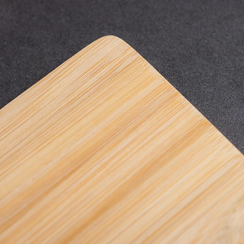 Light brown bamboo cutting board with handle slot