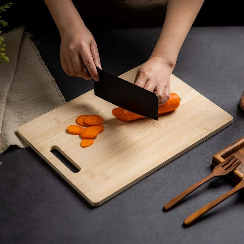Light brown bamboo cutting board with handle slot